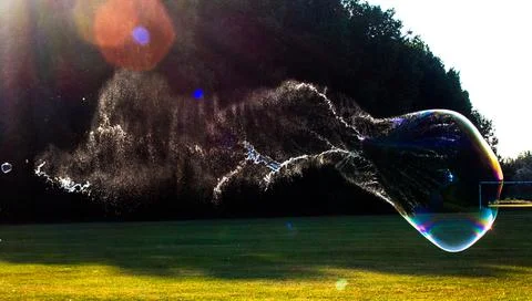 Giant bubble captured in the process of bursting Stock Photos