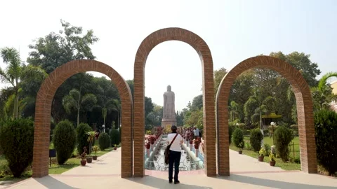 Giant buddha statue with isolated frame and devotee offering worship video is Stock Footage 314250263