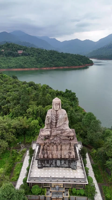 Giant Buddha Statue Overlooking a Serene Lake in Hue, Vietnam Stock Footage 335845901