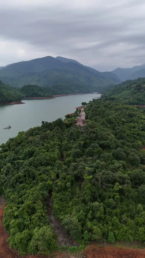 Giant Buddha Statue Watching Over Mountain Lake in Hue, Vietnam Video stock 335837121