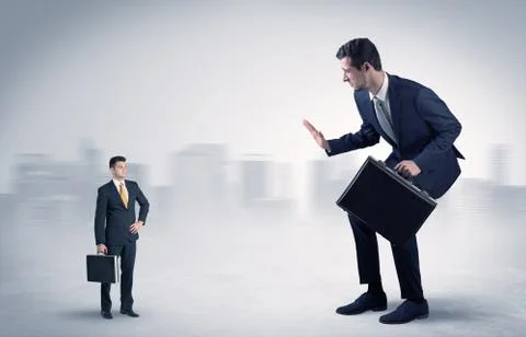 Giant businessman is  afraid of small executor Stock Photos