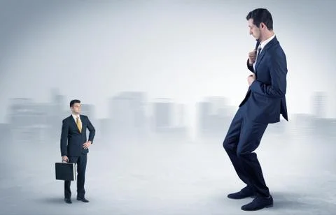 Giant businessman is  afraid of small executor Stock Photos