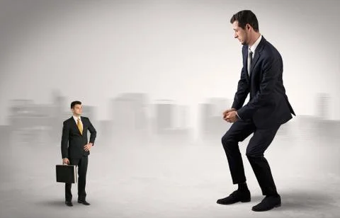 Giant businessman is  afraid of small executor Stock Photos