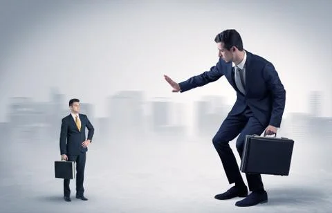 Giant businessman is  afraid of small executor Stock Photos