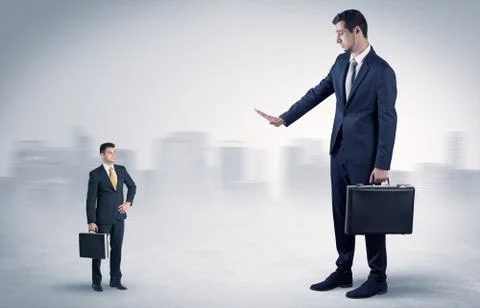 Giant businessman is  afraid of small executor Stock Photos