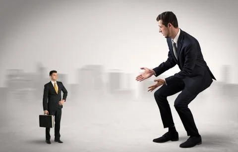 Giant businessman is  afraid of small executor Stock Photos