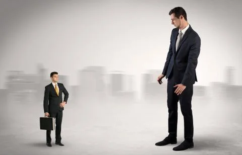 Giant businessman is  afraid of small executor Stock Photos