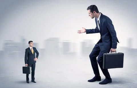 Giant businessman is  afraid of small executor Stock Photos