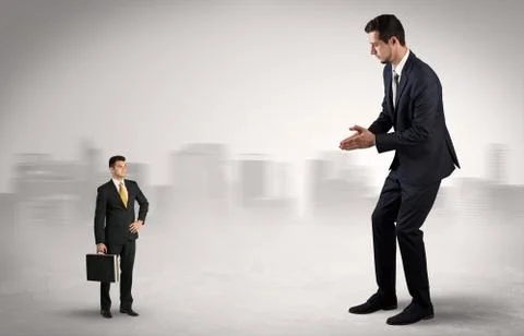 Giant businessman is  afraid of small executor Stock Photos