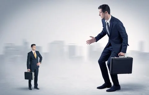 Giant businessman is  afraid of small executor Stock Photos