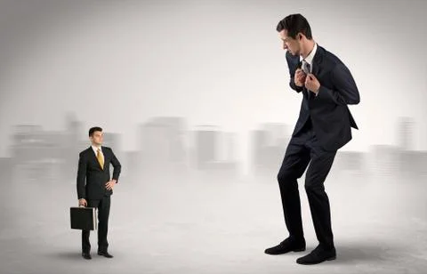 Giant businessman is  afraid of small executor Stock Photos