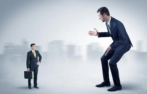 Giant businessman is  afraid of small executor Stock Photos