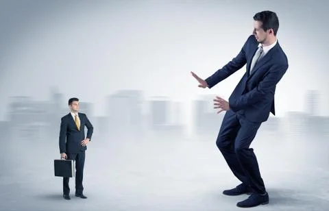Giant businessman is  afraid of small executor Stock Photos