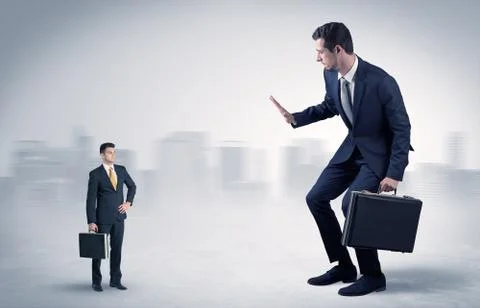 Giant businessman is  afraid of small executor Stock Photos