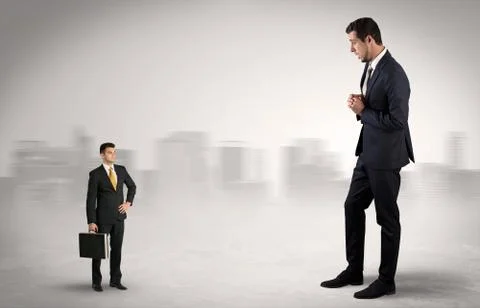 Giant businessman is  afraid of small executor Stock Photos