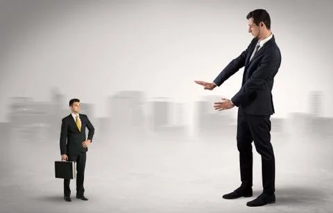 Giant businessman is  afraid of small executor Stock Photos
