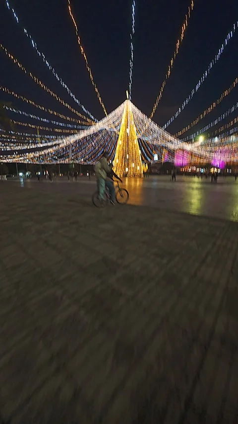 Giant Christmas Tree With Radiating String Lights Over City Square At Night.. Stock Footage 339985484