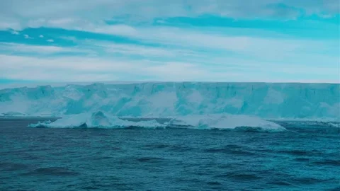 Giant crashed ice glacier arch in Antarctica. Huge iceberg ice wall in pink Stock Footage 324107192