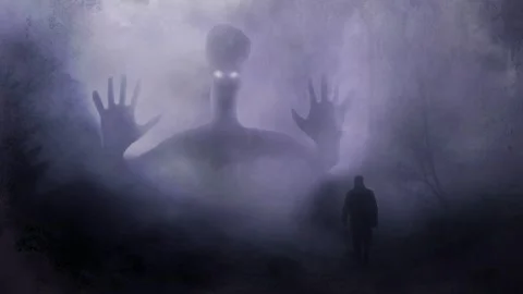 A giant creature ghost appears with glowing eyes behind man in foggy woods Stock Footage 327507815