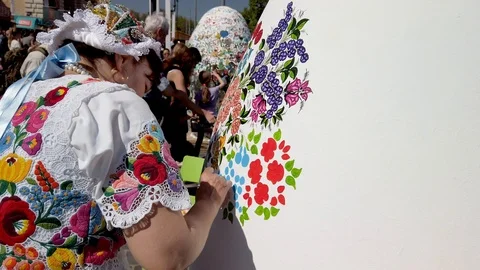 Giant Easter Egg is being decorated with folklore floral patterns Video stock 106808668