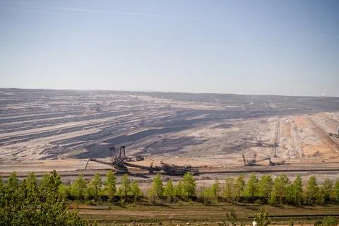 Giant excavators working in a massive open pit coal mine Stock Photos
