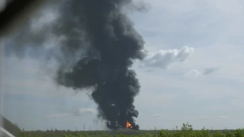 A giant fire and a column of black smoke after the explosion at the oil storage. Stock Footage 299903374
