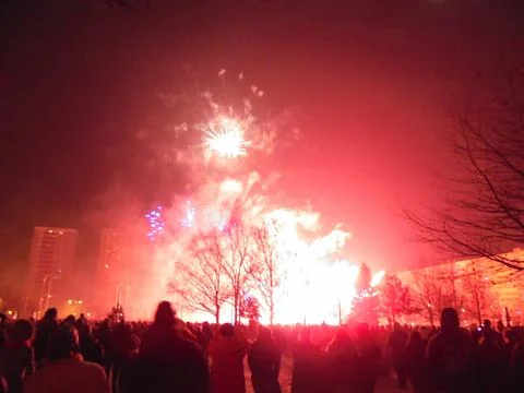 Giant flash of harsh red light created by fireworks explosion. Stock Photos