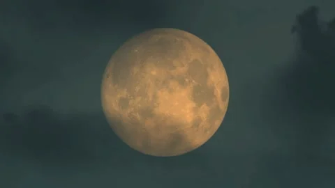 Giant Full Moon Glowing Orange Through Dark Clouds at Night Vídeos de archivo 339080232