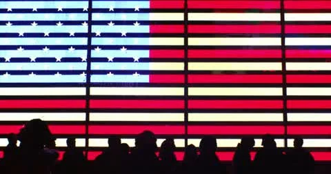 Giant glowing american flag neon sign in 4K with silhouettes Stock Footage