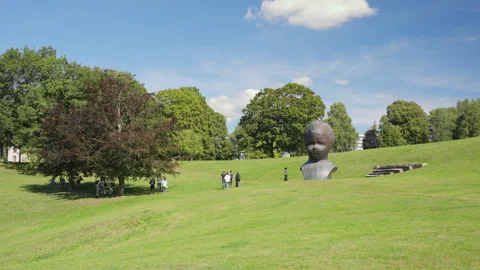 Giant Head N.N. Bronze Sculpture in Torshovdalen Park Oslo Stock Footage 344907682