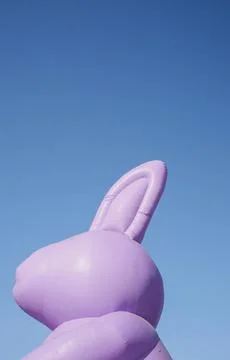 Giant inflatable purple Easter bunny head with the background of a clear bl.. Stock Photos