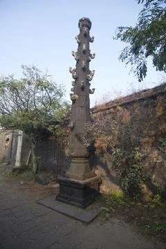 Giant lamp pillar outside the temple gate inside Kolaba fort, Alibaug, Mahara Stock Photos
