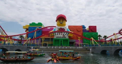 Giant Lego minifigure, roller coaster, and boats at Legoland Shanghai Stock Footage 336585632