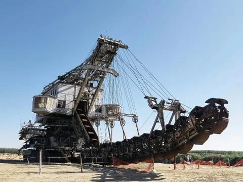 Giant old absetzer rusts in a sand quarry. Huge mining excavator. Stock Photos