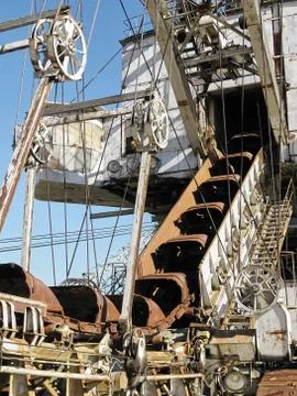 Giant old absetzer rusts in a sand quarry. Huge mining excavator. Stock Photos