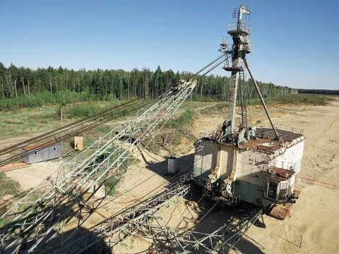 Giant old absetzer rusts in a sand quarry. Huge mining excavator. Stock Photos