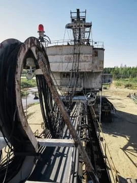 Giant old absetzer rusts in a sand quarry. Huge mining excavator. Stock Photos