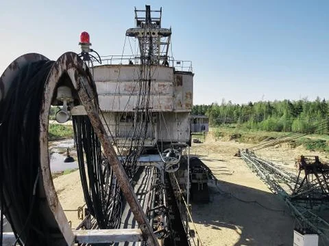 Giant old absetzer rusts in a sand quarry. Huge mining excavator. Stock Photos
