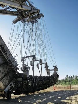 Giant old absetzer rusts in a sand quarry. Huge mining excavator. Stock Photos