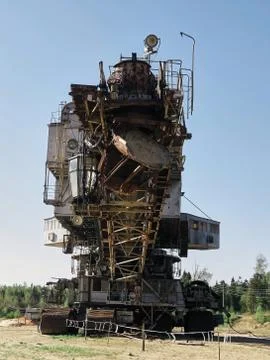 Giant old absetzer rusts in a sand quarry. Huge mining excavator. Stock Photos