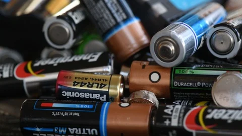 Giant pile of aa and aaa batterys for recycling Stock Footage 100822663