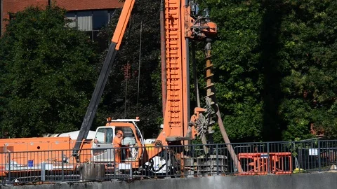 Giant pile driving machine drilling foundations on building site leeds uk Stock Footage 78633563