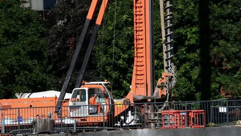 Giant pile driving machine drilling foundations on building site leeds uk Stock Footage 78635876