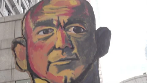 Giant puppet of Jeff Bezos, Amazon CEO, labeled as "Union Buster-in-Chief". Stock Footage 317673201