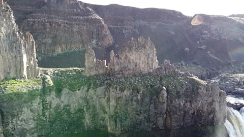 Giant rock formations towering over waterfall 스톡 동영상 331960181