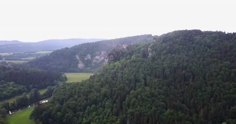 Giant rocks in a valley surrounded by an old forest Stock Footage 151323323