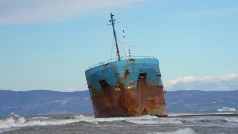 Giant Rusty Iron Ship Driven Ashore by Powerful Storm Stuck in Sand on Empty Stock Footage 331575143