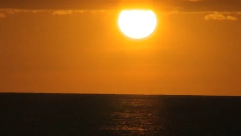 Giant setting sun over sea timelapse Stock Footage 74089249