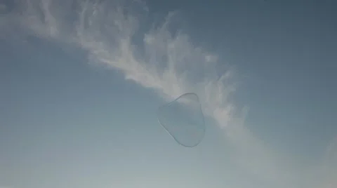 Giant Soap Bubble Floating in Air Against Blue Sky on Bright Sunny Day Stock Footage 22256595