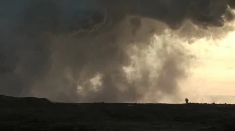 Giant Steam Cloud Obscures The Sun As Two Men Walk Across A Lava Field 스톡 동영상 19286009